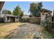 Backyard showing new garage with covered porch, playhouse, and mature trees at 229 Gordon St, Charleston, SC 29403