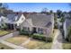 Aerial view of a charming home with a well-maintained yard, mature trees, and landscaped features at 229 Gordon St, Charleston, SC 29403