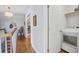 Bright hallway featuring hardwood floors, fresh white walls, and access to laundry and other rooms at 229 Gordon St, Charleston, SC 29403
