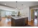 Modern kitchen with stainless steel appliances and a marble-topped island is open to the living room at 229 Gordon St, Charleston, SC 29403