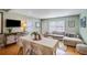 Open living and dining space with hardwood floors and large windows provides ample natural light at 229 Gordon St, Charleston, SC 29403