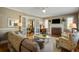 Bright living room featuring a fireplace, hardwood floors, and French doors to another living space at 229 Gordon St, Charleston, SC 29403