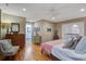 Spacious bedroom featuring hardwood floors, a ceiling fan, and abundant natural light at 229 Gordon St, Charleston, SC 29403