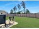 This backyard features a lush lawn, a cozy patio, and a beautiful privacy fence at 265 Celestial Blvd, Summerville, SC 29486