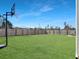 Expansive backyard with lush green grass, a basketball hoop, and a fence for privacy at 265 Celestial Blvd, Summerville, SC 29486