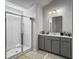 Bright bathroom featuring a walk-in shower with glass doors and a gray vanity with modern fixtures at 265 Celestial Blvd, Summerville, SC 29486