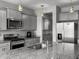 Spacious kitchen features gray cabinets, stainless steel appliances, and a large granite island at 265 Celestial Blvd, Summerville, SC 29486