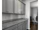 Gray kitchen cabinets with granite countertops and silver hardware with view into the living room at 265 Celestial Blvd, Summerville, SC 29486