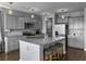 Modern kitchen with gray cabinets, stainless steel appliances, and a large granite-topped island with seating at 265 Celestial Blvd, Summerville, SC 29486