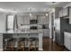 Gray cabinets, stainless appliances, and a granite island make this a modern and functional kitchen at 265 Celestial Blvd, Summerville, SC 29486