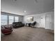 Spacious living room with a dark leather couch, tv, gaming chair, and bright natural light at 265 Celestial Blvd, Summerville, SC 29486