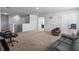 Expansive living room with dark leather couch, gaming chair, and bright natural light at 265 Celestial Blvd, Summerville, SC 29486