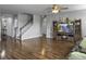Open living room features hardwood floors, stair access, and cozy entertainment center at 265 Celestial Blvd, Summerville, SC 29486
