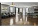 Open-concept living room with hardwood floors, natural light, and easy access to kitchen and dining at 265 Celestial Blvd, Summerville, SC 29486