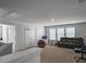 Bright living room area features a gaming chair, dark leather couch, and natural light at 265 Celestial Blvd, Summerville, SC 29486