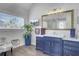 Elegant bathroom featuring a blue vanity, large mirror, and TV at 2745 Oak Manor Dr, Mount Pleasant, SC 29466