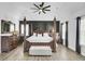 A primary bedroom featuring a four-poster bed, modern flooring, and neutral decor at 2745 Oak Manor Dr, Mount Pleasant, SC 29466