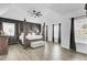 Spacious primary bedroom featuring a four-poster bed, ample natural light, and modern flooring at 2745 Oak Manor Dr, Mount Pleasant, SC 29466