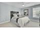 Cozy bedroom with a wooden headboard, stylish bedding, and a window providing natural light at 2745 Oak Manor Dr, Mount Pleasant, SC 29466