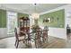 Formal dining room boasts wainscoting, a large table, and a charming chandelier at 2745 Oak Manor Dr, Mount Pleasant, SC 29466