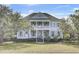 Beautiful two-story home with classic architectural details and a well-manicured lawn at 2745 Oak Manor Dr, Mount Pleasant, SC 29466