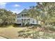 Charming two-story home with a welcoming front porch and lush landscaping at 2745 Oak Manor Dr, Mount Pleasant, SC 29466