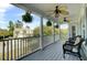 Inviting front porch featuring dual fans, hanging ferns, and comfortable wicker chairs at 2745 Oak Manor Dr, Mount Pleasant, SC 29466