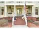 Inviting front porch adorned with colorful flowers and charming architectural details at 2745 Oak Manor Dr, Mount Pleasant, SC 29466