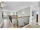 Hallway with wood flooring, a view of a bedroom, and elegant lighting at 2745 Oak Manor Dr, Mount Pleasant, SC 29466