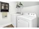 Functional laundry room with a washer, dryer, shelving, and hardwood floors at 2745 Oak Manor Dr, Mount Pleasant, SC 29466