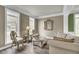 Bright formal living room features hardwood floors, large windows, and an ornate mirror at 2745 Oak Manor Dr, Mount Pleasant, SC 29466