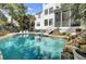 Relaxing pool area with adjacent patio seating, perfect for outdoor entertaining and enjoying the beautiful surroundings at 2745 Oak Manor Dr, Mount Pleasant, SC 29466