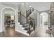 Elegant staircase with hardwood flooring and detailed iron railings at 2745 Oak Manor Dr, Mount Pleasant, SC 29466