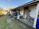 Back porch needing repair and decluttering, adjacent to a grassy yard at 28 Gordon St, Charleston, SC 29403