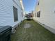 View of a narrow driveway running between two houses, ending with a dark SUV at 28 Gordon St, Charleston, SC 29403