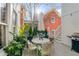 Charming back patio with outdoor dining set, lush greenery, and adjacent staircase at 3019 Viscount St, Charleston, SC 29424