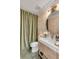 Elegant bathroom featuring unique wallpaper, stylish vanity, and shower with green velvet curtains at 3019 Viscount St, Charleston, SC 29424