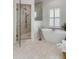 Bright bathroom with modern tub, glass-enclosed shower, and tiled floors at 3019 Viscount St, Charleston, SC 29424