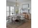 Elegant dining room with a modern light fixture, stylish furniture, and an oversized art piece at 3019 Viscount St, Charleston, SC 29424