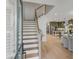 Elegant entryway featuring a staircase leading to an open-concept living area and kitchen with hardwood floors at 3019 Viscount St, Charleston, SC 29424