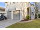 Charming home featuring a two-car garage, second-story entrance, manicured lawn, and lush landscaping at 3019 Viscount St, Charleston, SC 29424