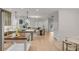 Open-concept kitchen and living room features a kitchen island with seating, and an entryway in the background at 3019 Viscount St, Charleston, SC 29424