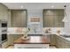 Well-appointed kitchen with custom cabinets, stainless appliances, and butcher block center island at 3019 Viscount St, Charleston, SC 29424