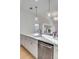 Bright kitchen with white cabinetry, stainless steel appliances, and stylish pendant lighting over the countertop at 3019 Viscount St, Charleston, SC 29424