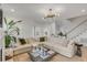 Bright living room with a large sectional sofa, modern lighting, and views of the well-landscaped yard at 3019 Viscount St, Charleston, SC 29424