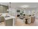 Open-concept kitchen and living room with white walls, light wood floors, and lots of natural light at 3019 Viscount St, Charleston, SC 29424