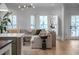 Bright living room featuring a sectional couch, bay windows with shutters, and modern decor at 3019 Viscount St, Charleston, SC 29424