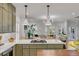 Open-concept kitchen flows into a bright living area with a large sofa and a view of the bay windows at 3019 Viscount St, Charleston, SC 29424