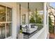 Relaxing porch features a cozy swing and outdoor seating area with neutral tones at 3019 Viscount St, Charleston, SC 29424
