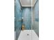 Blue tiled walk-in shower with a wood stool and gold fixtures at 3019 Viscount St, Charleston, SC 29424